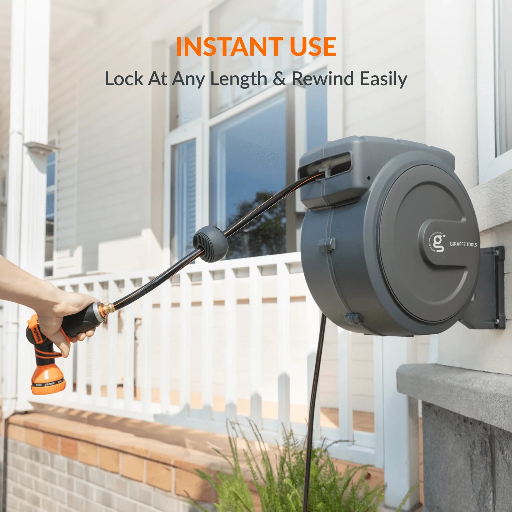 Giraffe Tools Retractable Garden Hose Reel in a backyard setting