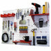 Wall-mounted tool organizer with various tools on a white pegboard