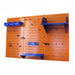 Orange pegboard wall with blue shelves and hooks on a white background
