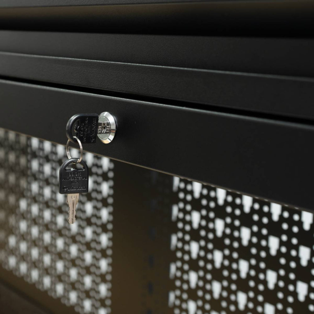 Close-up of a black metal cabinet with a key attached to the lock, featuring a patterned background.