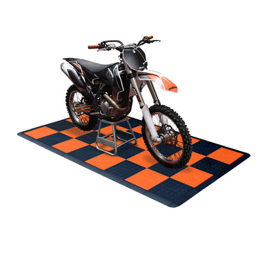 Dirt bike on a checkered orange and blue mat