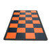 Checkered mat with orange and black squares on a white background