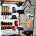 Organized garage wall with tools on a steel pegboard
