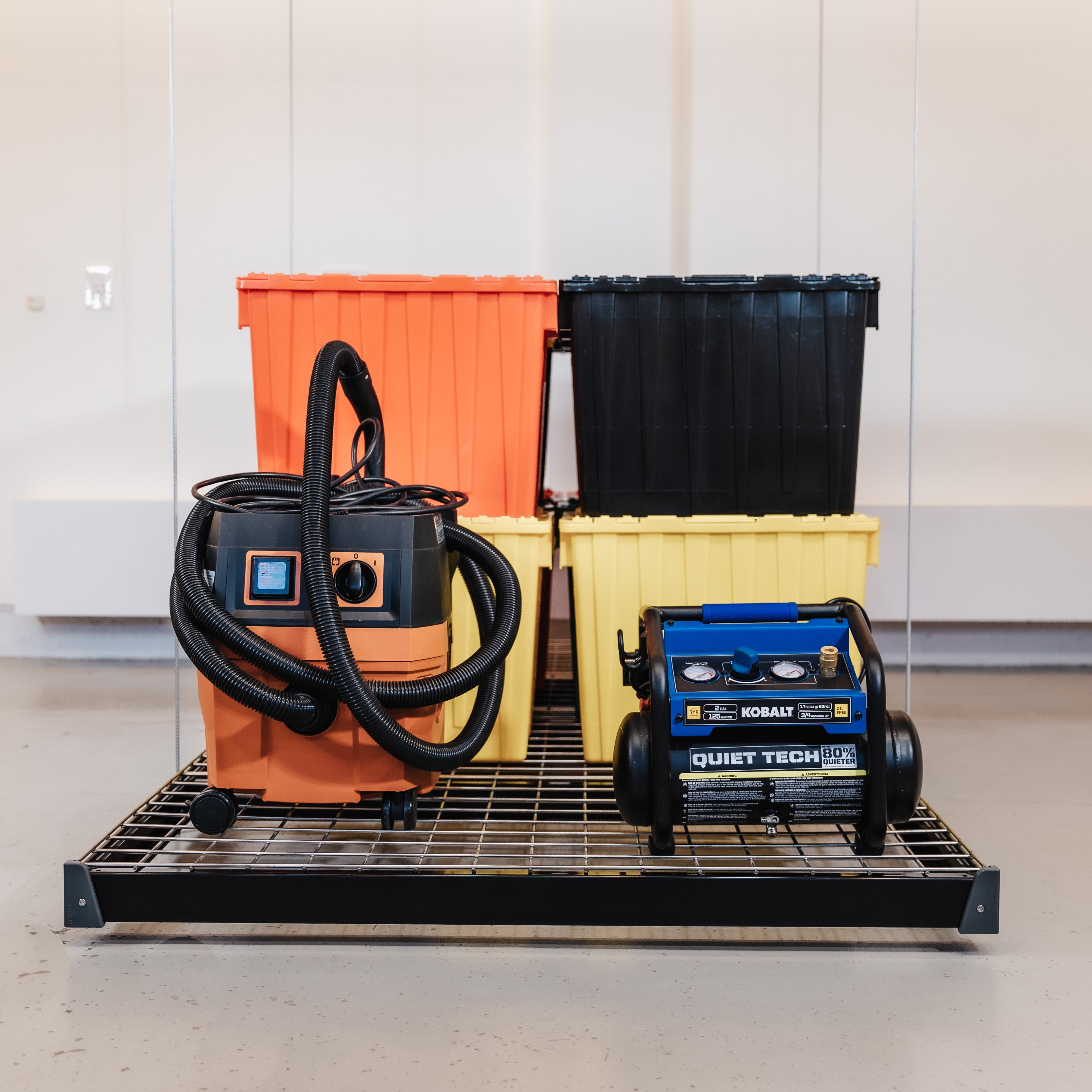 Auxx-Lift Motorized Garage Ceiling Storage Lift with totes and vacuum