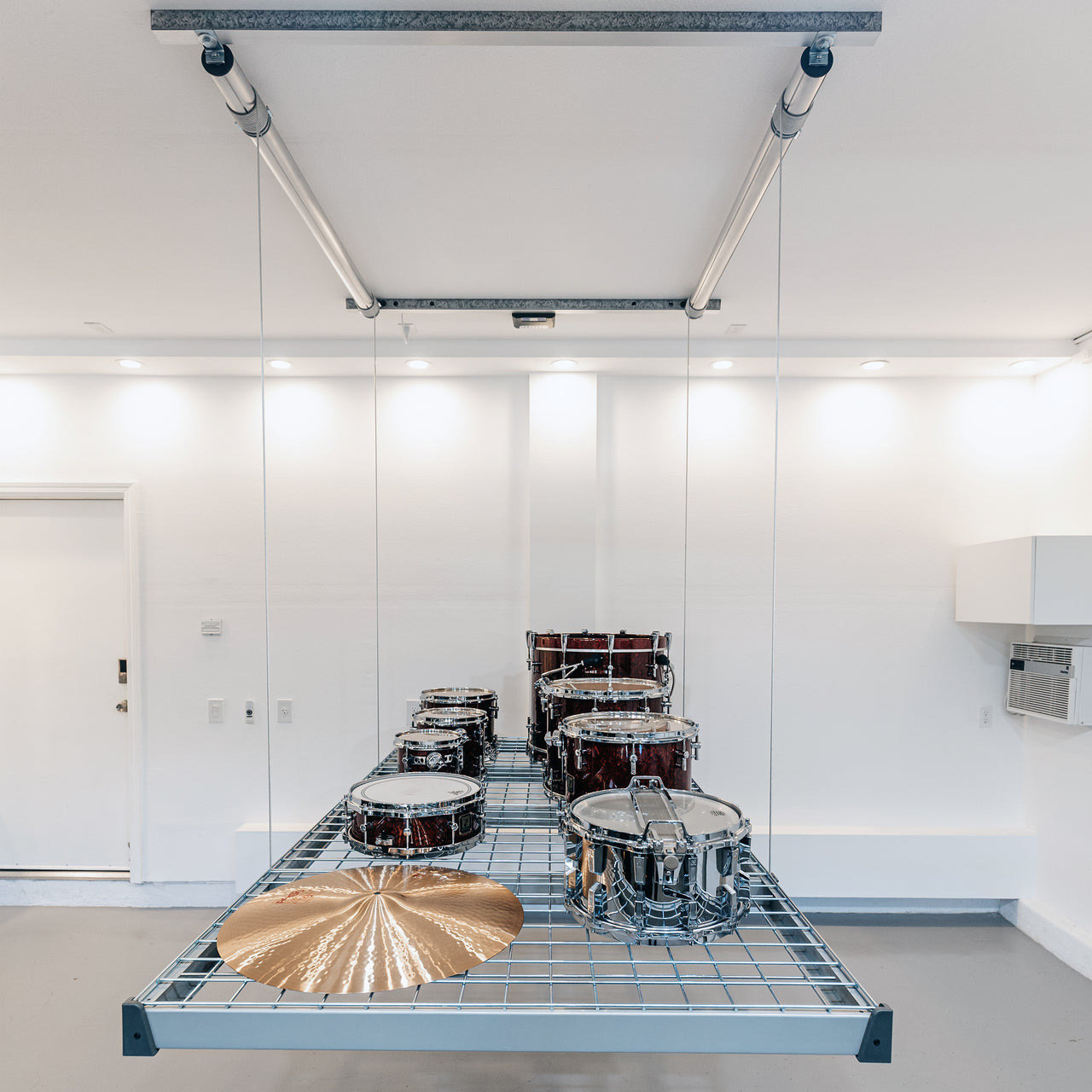 Auxx-Lift Motorized Garage Ceiling Storage Lift lowered with drum kit