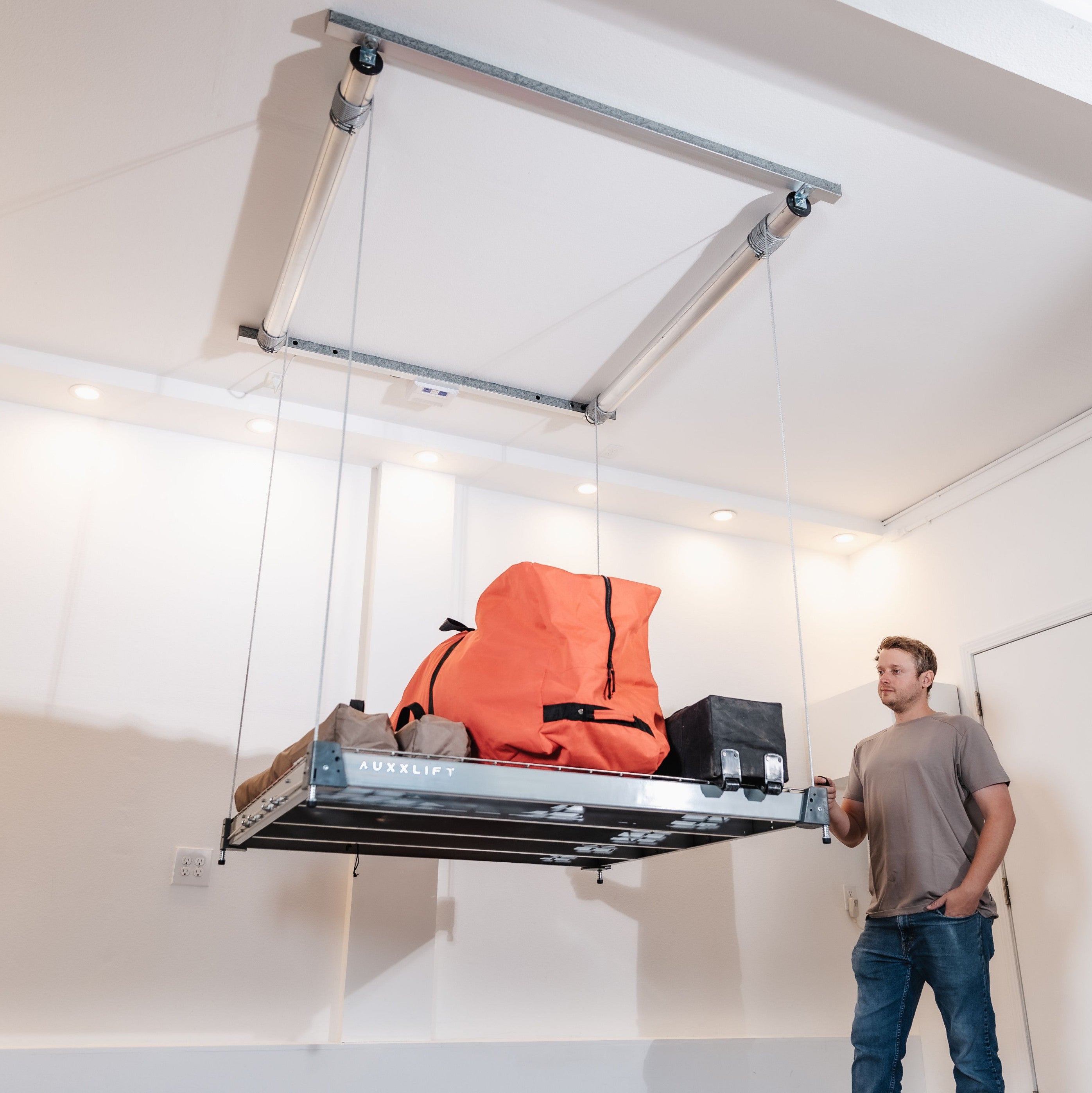 Auxx-Lift Motorized Garage Ceiling Storage Lift lowered with orange bag