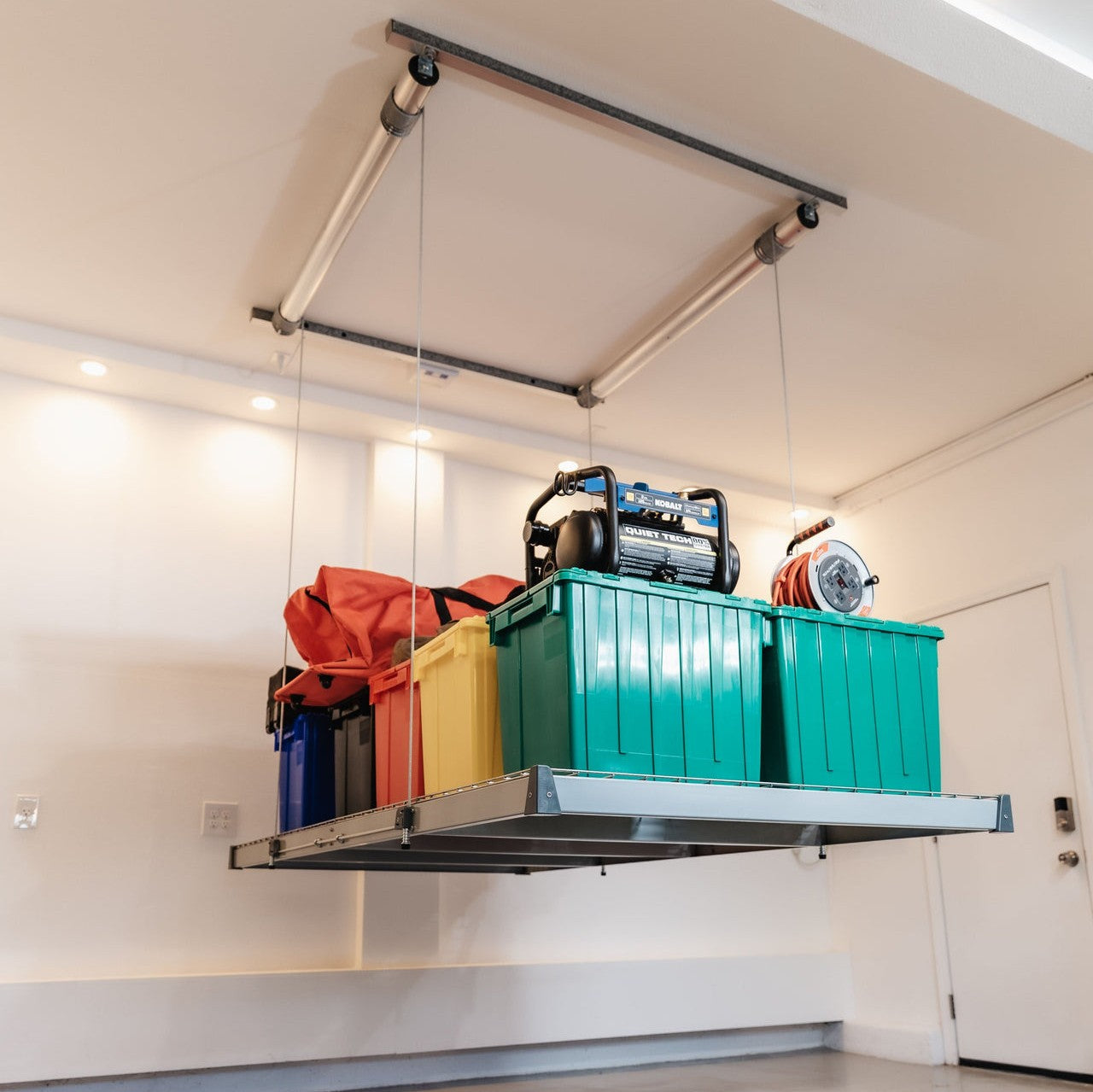 Auxx-Lift Motorized Garage Ceiling Storage Lift with colorful totes