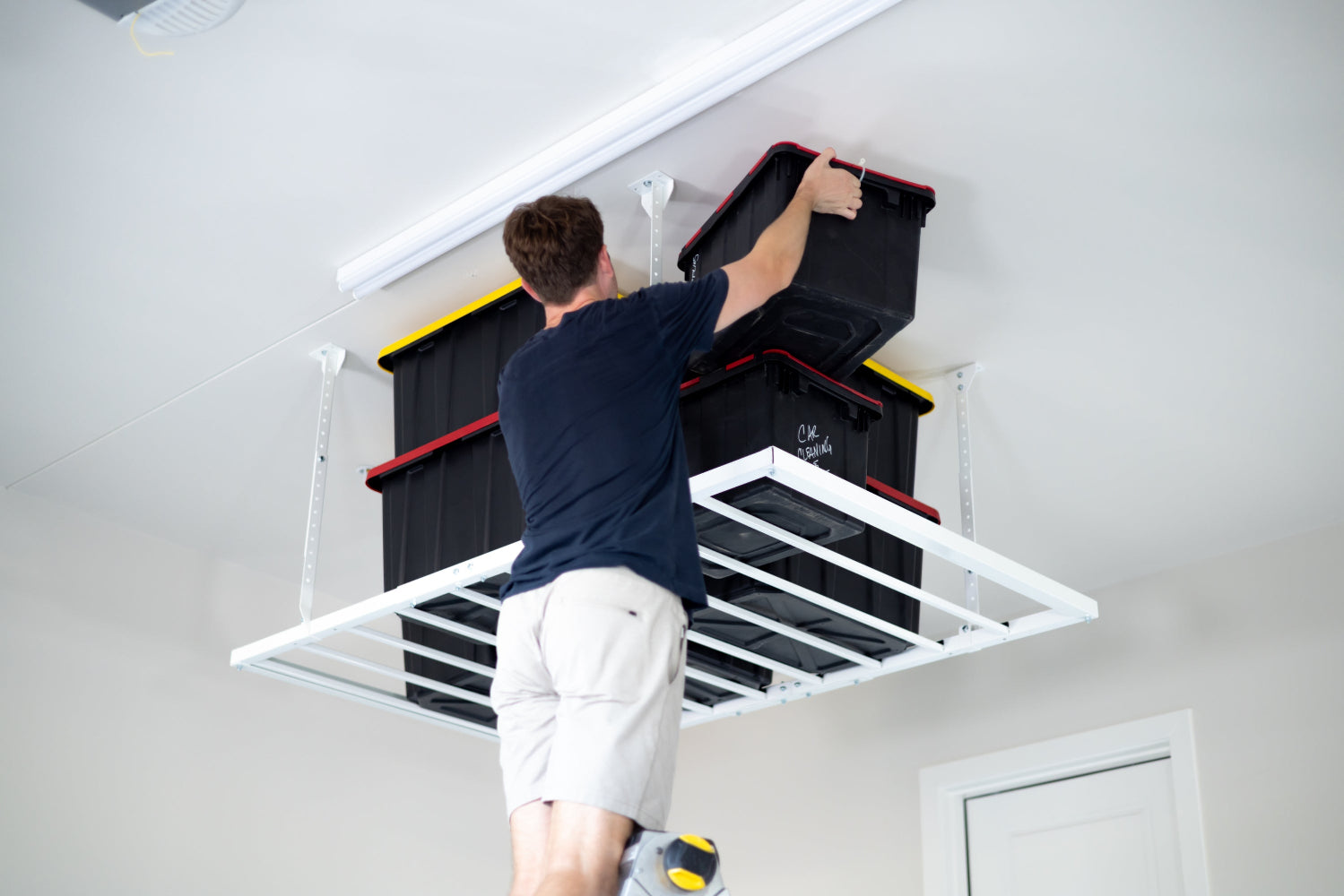 ceiling-sam-heavy-duty-pro-4x6-installed-man-storing-totes