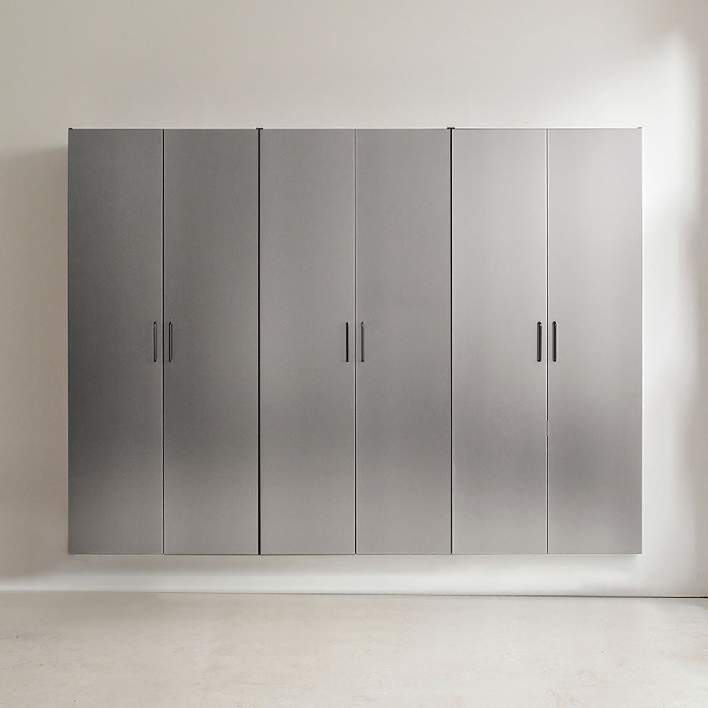 Set of five gray storage cabinets with black handles on a white wall.