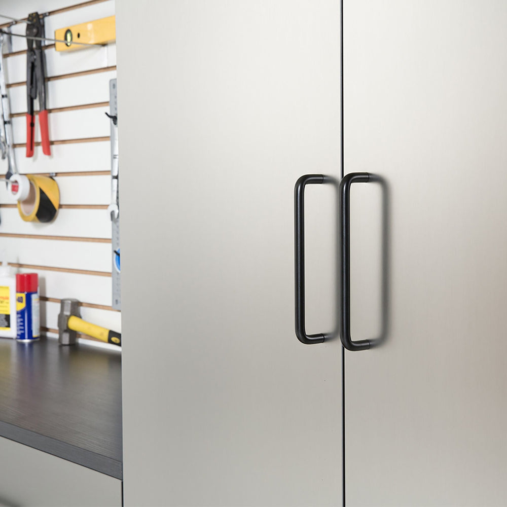 Metal cabinet with black handle in a workshop setting