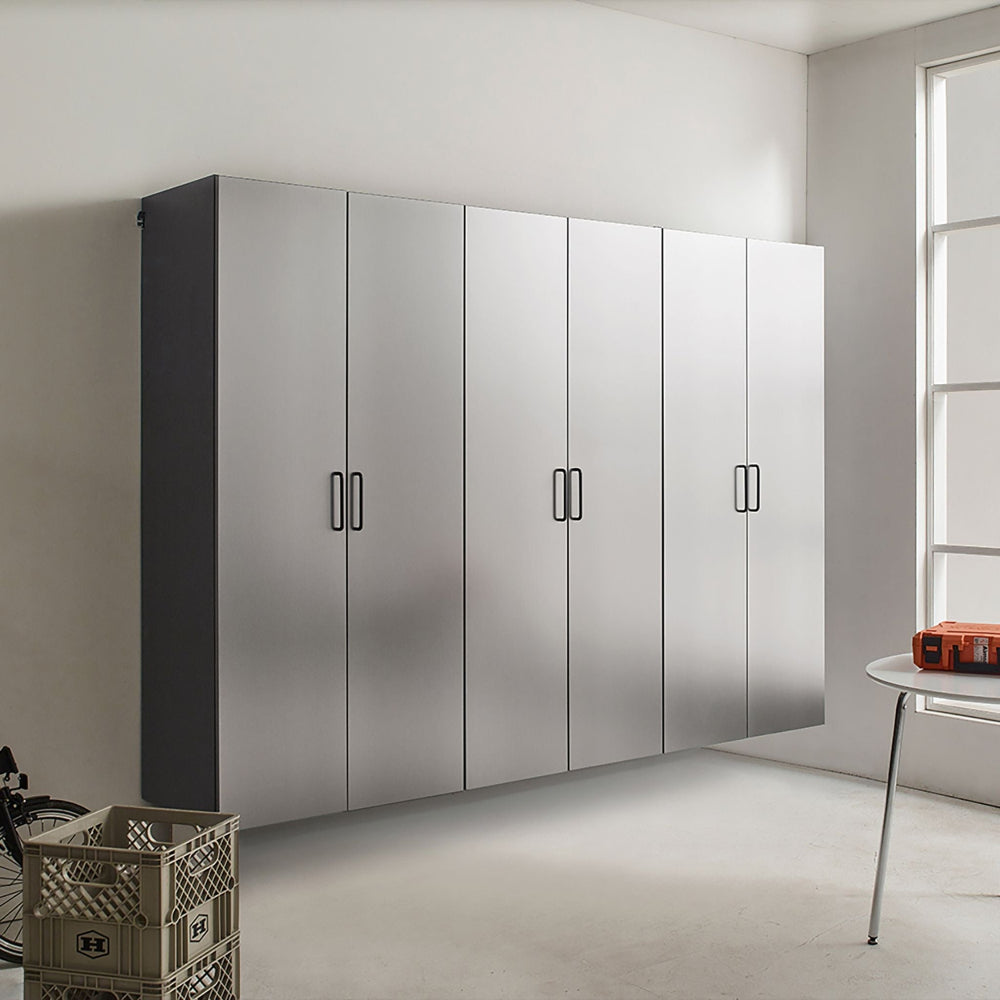 Modern metallic garage cabinet in a minimalistic room with a bicycle and table in the foreground.